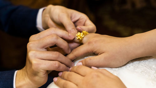 Midsection of couple holding hands