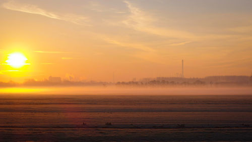 Scenic view of landscape against sky during sunset