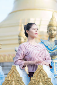 Statue of buddha against building