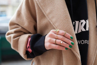 Rings and green nails