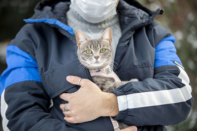 Full length portrait of woman holding cat