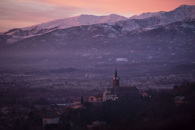 High angle view of townscape against sky during sunset in pinerolo