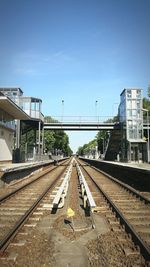 Railroad tracks against sky on sunny day