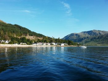 Scenic view of lake and mountains against sky