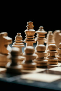 Close-up of chess pieces against black background