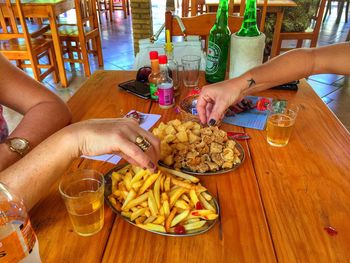 Midsection of woman eating food on table