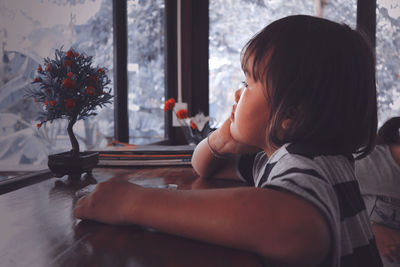 Close-up of cute girl sitting at cafe