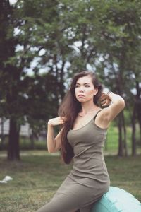 Woman looking away while sitting in public park