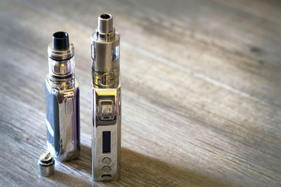 High angle view of electronic cigarette on wooden table