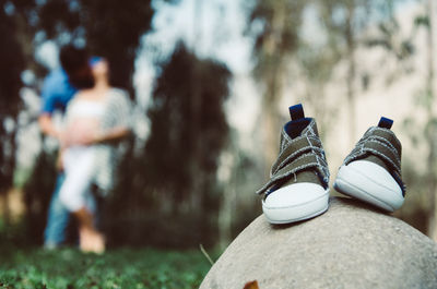 Close-up of shoes on rock