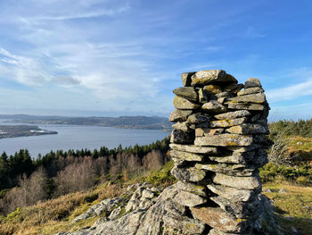 Stack of rocks on shore against sky