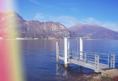 Scenic view of sea and mountains against blue sky