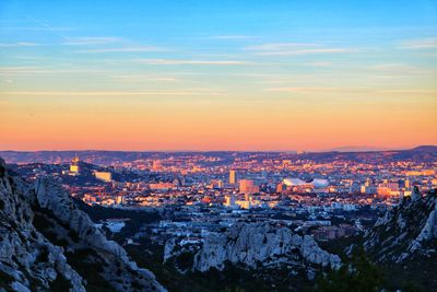 High angle view of buildings against sky during sunset