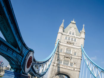 Low angle view of bridge against blue sky