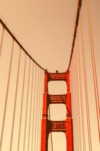 Low angle view of suspension bridge against sky during sunset