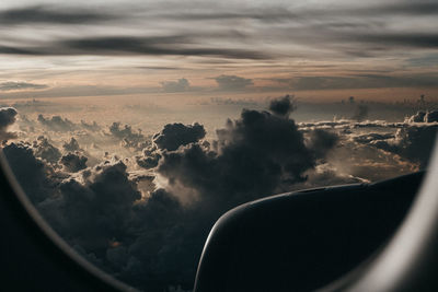 Aerial view of cloudscape seen through airplane window