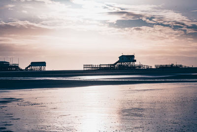 View of beach against cloudy sky