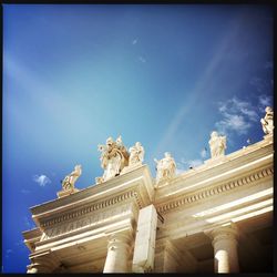 Low angle view of statue against blue sky