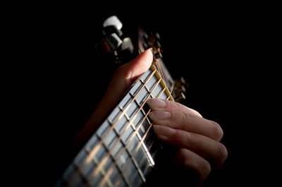 Cropped hand of person playing guitar