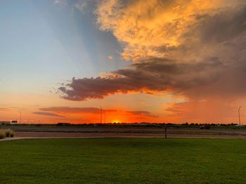 Scenic view of field against sky during sunset