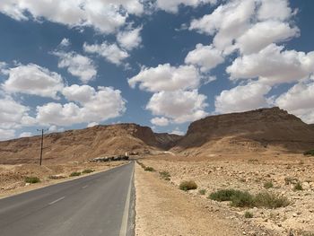 Empty road along countryside landscape