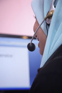 Female customer service representative using computer in office
