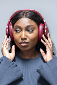 Portrait of young woman with eyes closed headphones