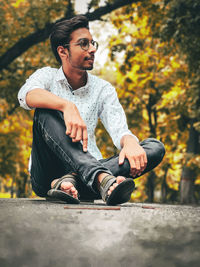 Young man sitting on bench