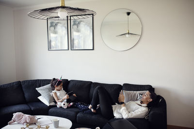 Mother and daughter on sofa