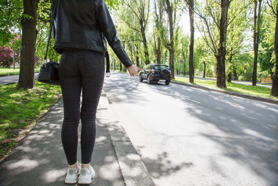 Rear view of man walking on road