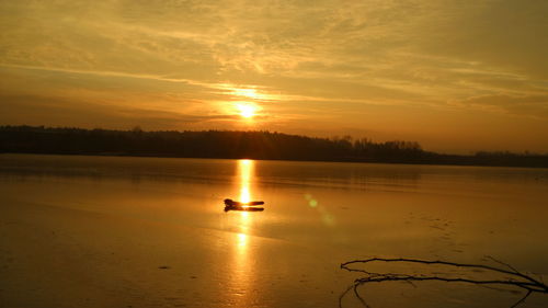 Scenic view of lake against sky during sunset