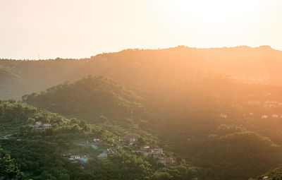 Scenic view of mountains against sky at sunset