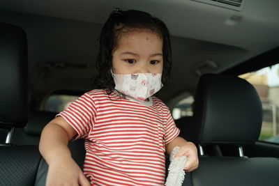 Portrait of woman sitting in car