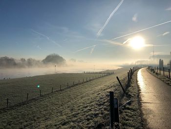 Scenic view of field against sky during winter