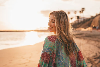 Young woman standing at beach