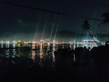 Silhouette sailboats in sea against sky at night