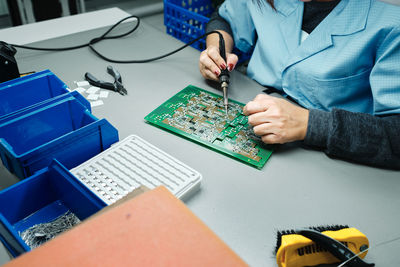 Low section of man working on table