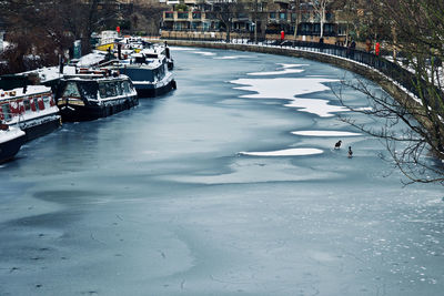 High angle view of frozen moored in city during winter