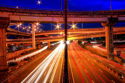 Light trails on road in city at night