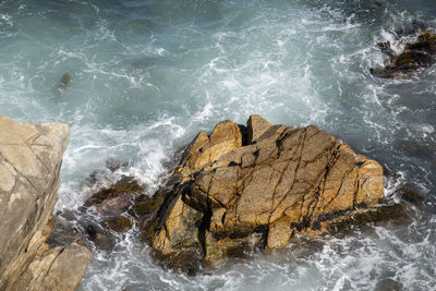 High angle view of rocks in sea