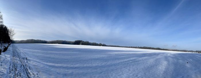 Scenic view of snow covered landscape against sky