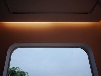 Low angle view of sky seen through train window