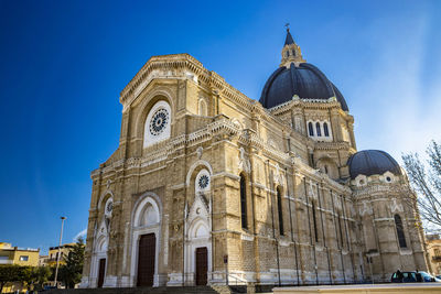 Low angle view of historical building against blue sky