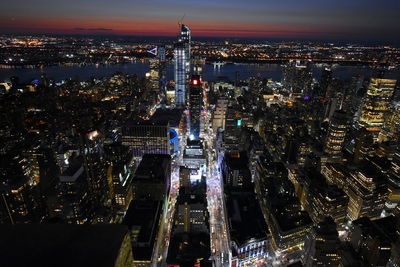 High angle view of illuminated city buildings at night