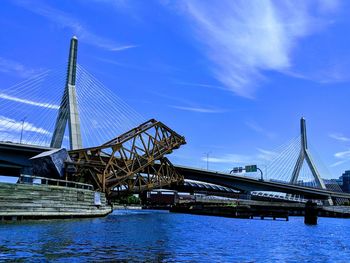 View of bridge over river against cloudy sky