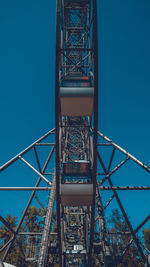 Low angle view of ferris wheel against blue sky