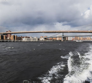 View of bridge over sea against cloudy sky