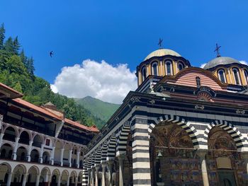 Low angle view of temple building against blue sky