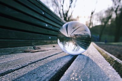 Close-up of crystal ball on wooden surface