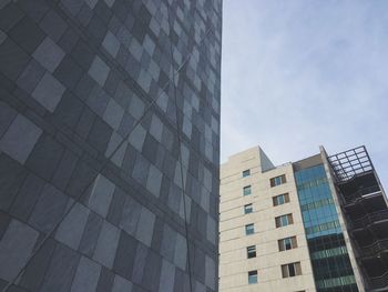 Low angle view of modern buildings against sky in city